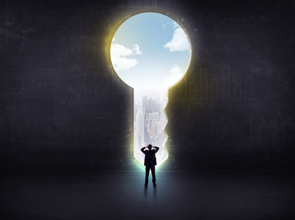 businessman-looking-through-a-big-key-solution-concept